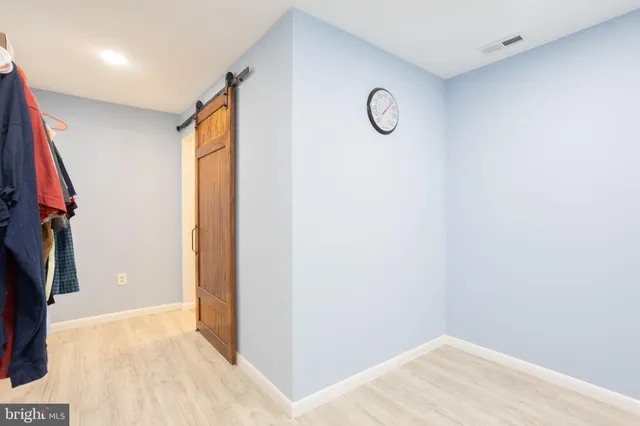 a view of a closet and a mirror