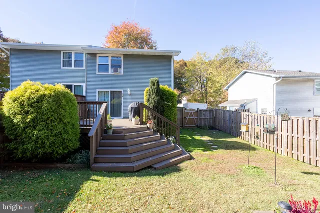 a view of a deck with furniture and trees around