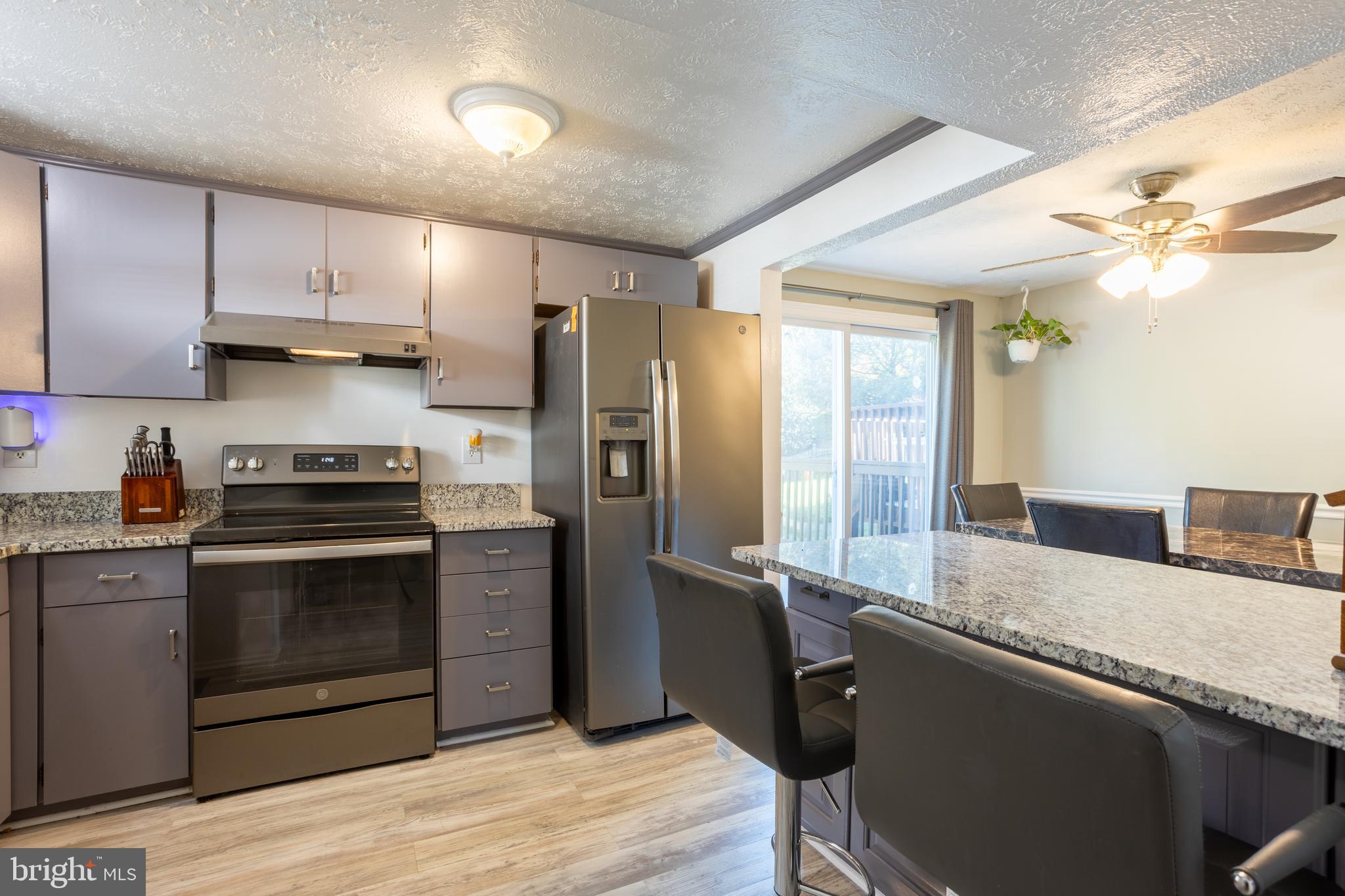1583 Star Pine Drive Annapolis, MD 21409 - Photo 10 of 37 a kitchen with granite countertop a stove cabinets and refrigerator