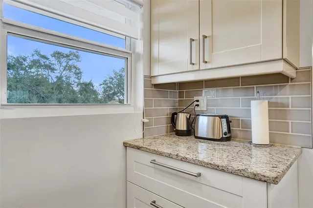 a kitchen with a sink and granite counter tops