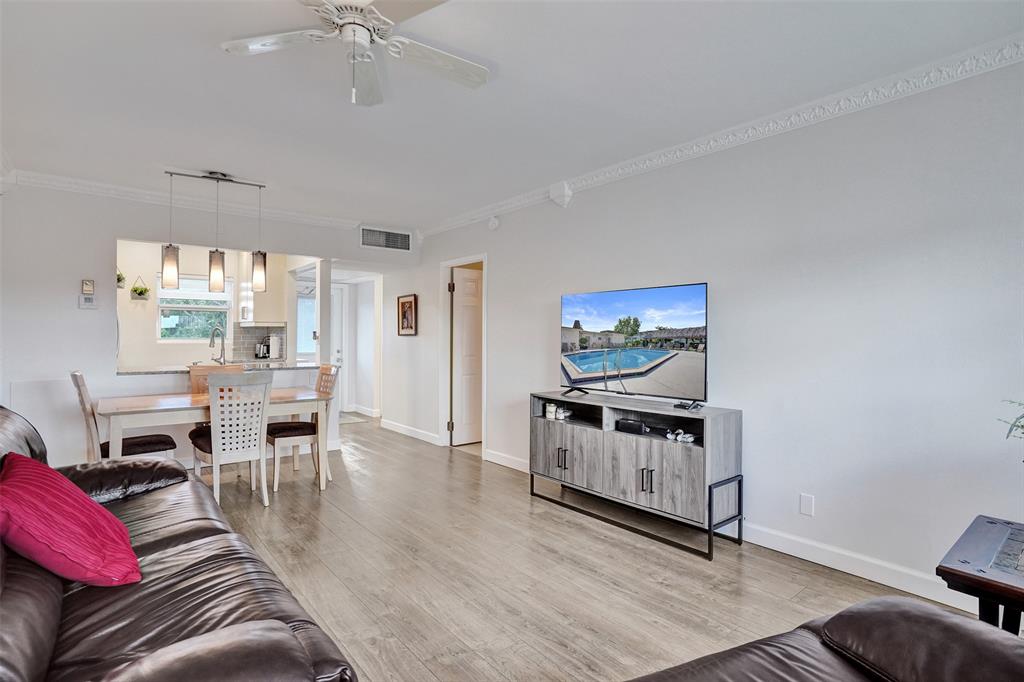 3405 Northwest 48th Avenue, Unit 611 Lauderdale Lakes, FL 33319 - Photo 18 of 34 a living room with furniture and a flat screen tv