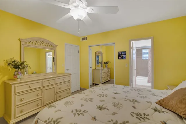 a bedroom with a bed and a dresser in it