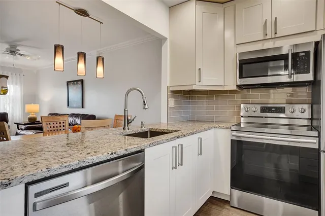 a kitchen with granite countertop a stove and a sink