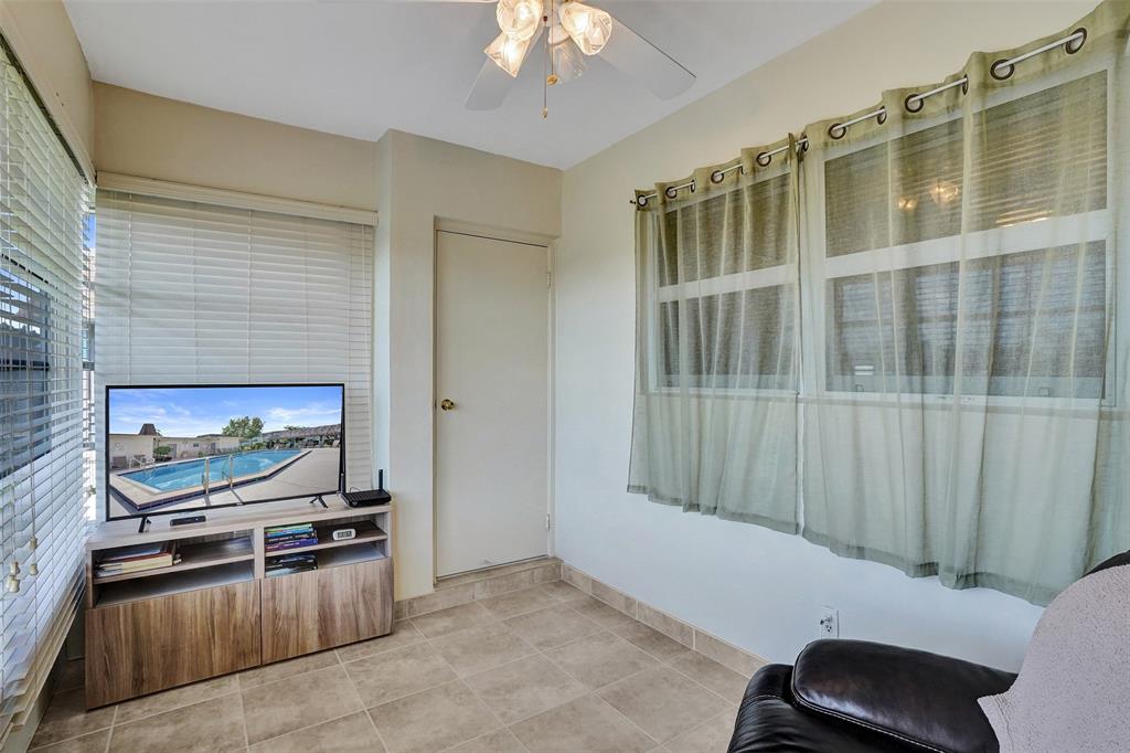 3405 Northwest 48th Avenue, Unit 611 Lauderdale Lakes, FL 33319 - Photo 22 of 34 a living room with furniture and a flat screen tv