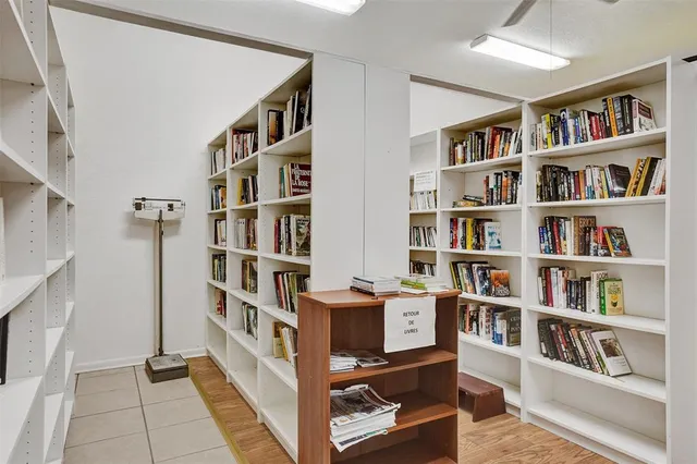 a view of room with cabinets and book shelf