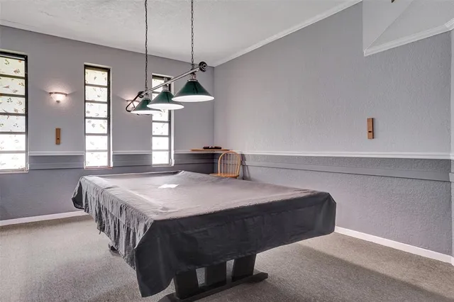 a bedroom with a bed a chandelier and a window