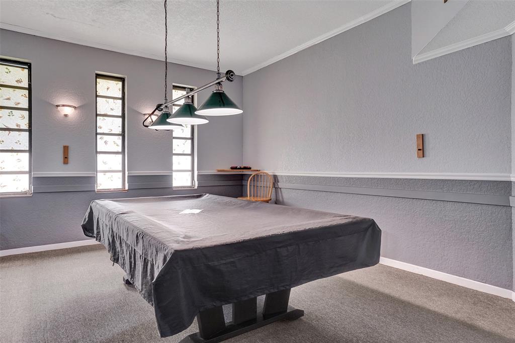 3405 Northwest 48th Avenue, Unit 611 Lauderdale Lakes, FL 33319 - Photo 24 of 34 a bedroom with a bed a chandelier and a window