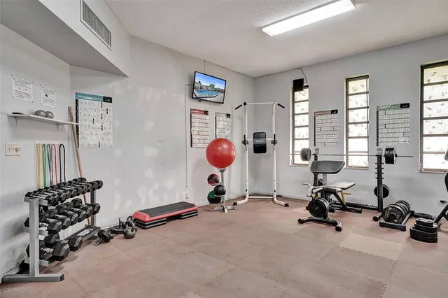 a room with gym equipment and a large window