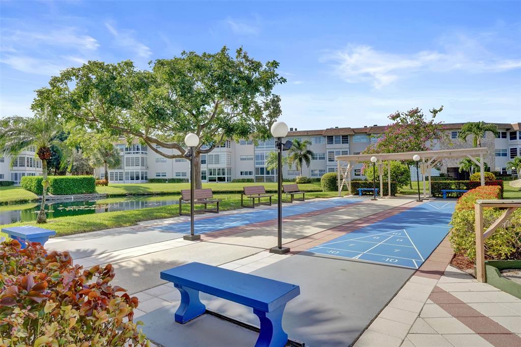 3405 Northwest 48th Avenue, Unit 611 Lauderdale Lakes, FL 33319 - Photo 29 of 34 a park view with a bench in the patio