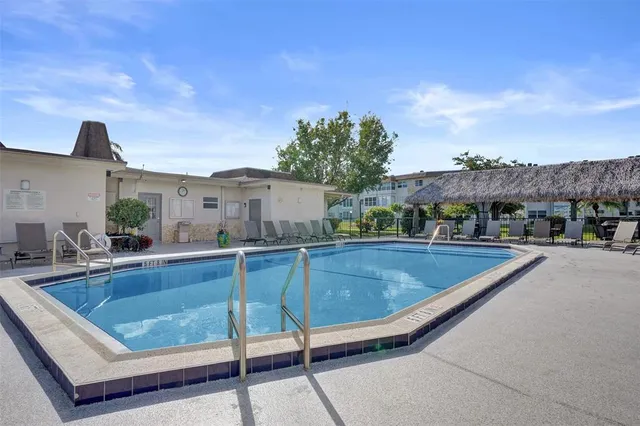 a view of a swimming pool with a patio and a terrace