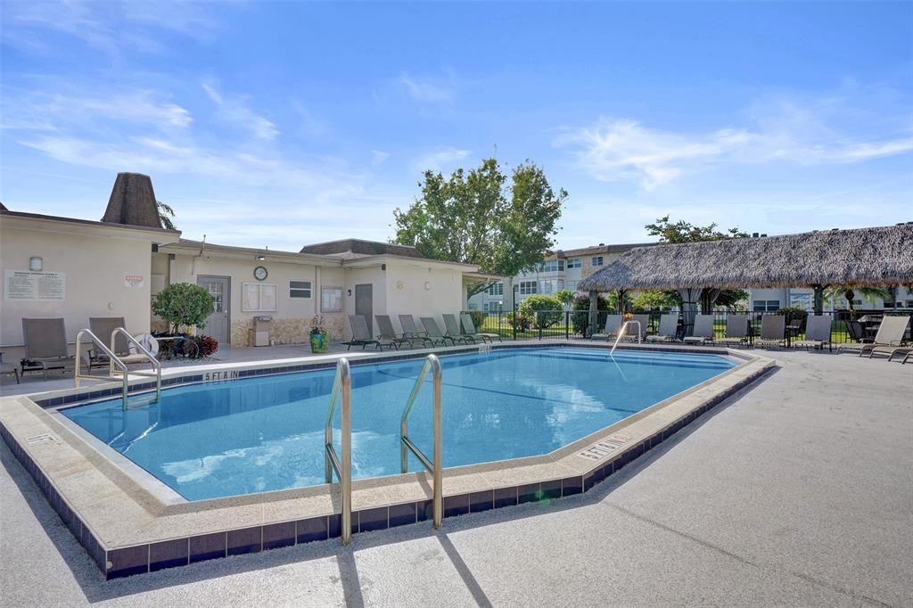 3405 Northwest 48th Avenue, Unit 611 Lauderdale Lakes, FL 33319 - Photo 32 of 34 a view of a swimming pool with a patio and a terrace