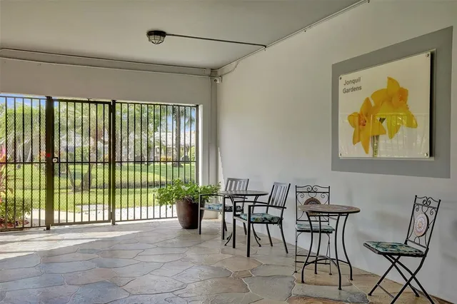 a view of a dining room with furniture and a floor to ceiling window
