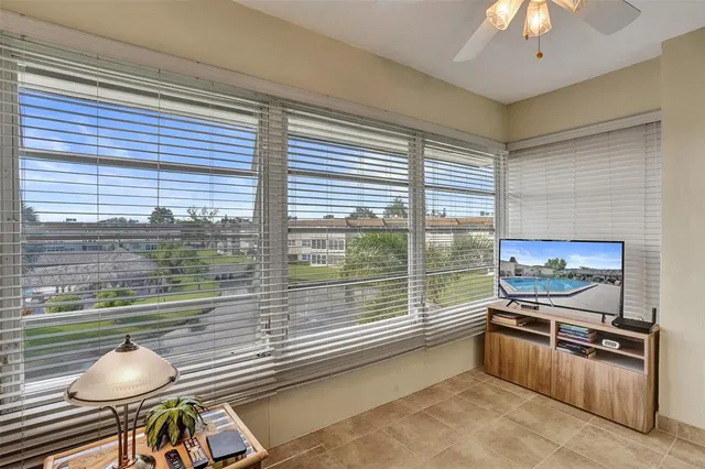 a kitchen with stainless steel appliances wooden floor and a large window