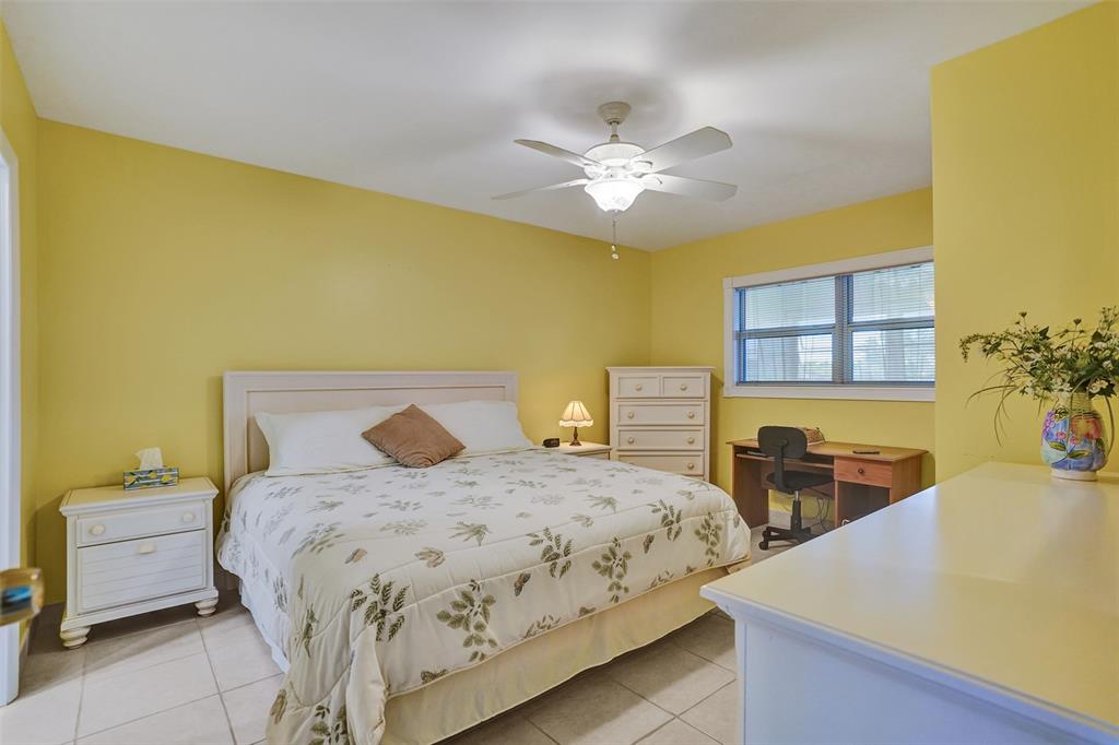 3405 Northwest 48th Avenue, Unit 611 Lauderdale Lakes, FL 33319 - Photo 6 of 34 a bedroom with a bed and a chandelier