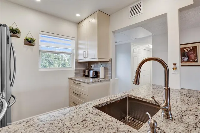 a kitchen with a sink a stove and a refrigerator