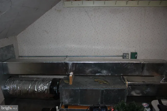 a view of a brick building with a bench in front of building