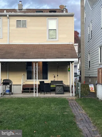 a view of a house with a yard and a fireplace