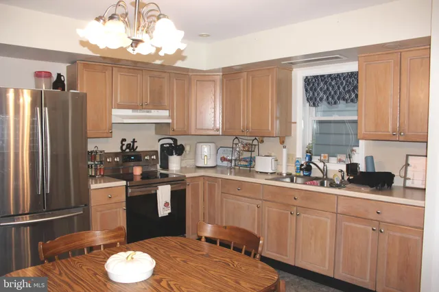 a kitchen with a sink stove and refrigerator
