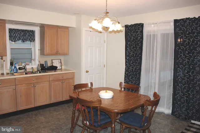a kitchen with a table and chairs in it