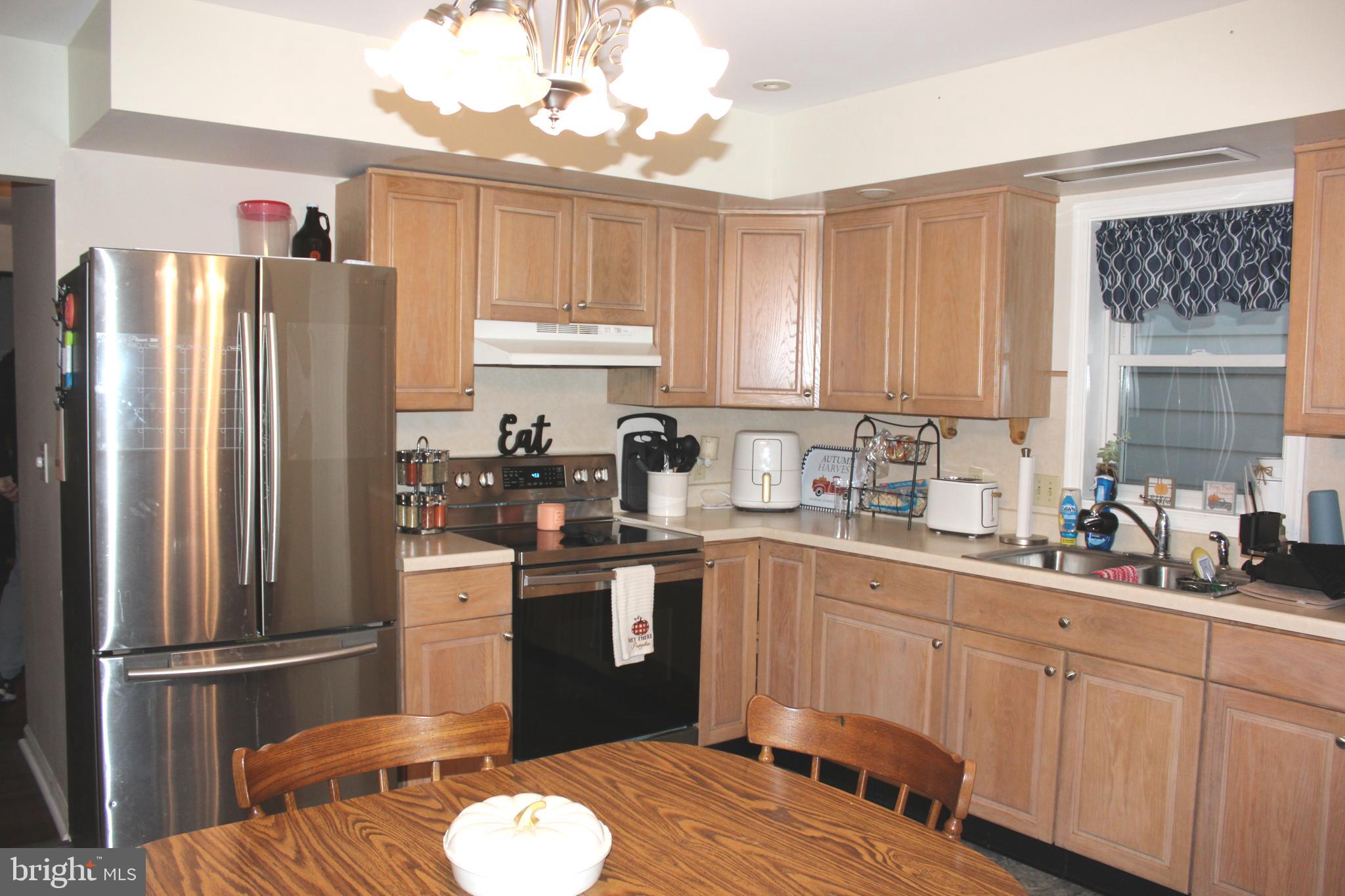 320 South Mill Street St. Clair, PA 17970 - Photo 10 of 37 a kitchen with a refrigerator sink and cabinets