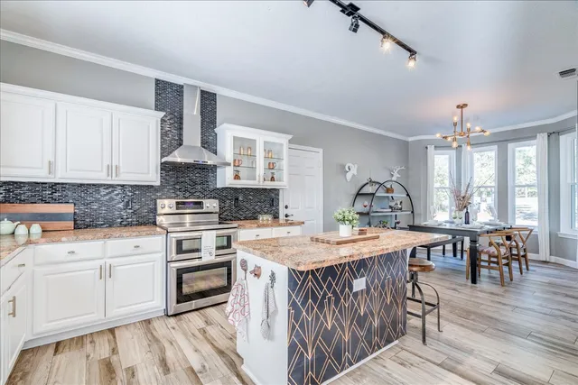 a kitchen with a table chairs stove and cabinets