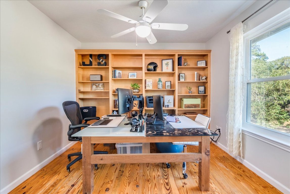 171 Pin Oak Crossing Elgin, TX 78621 - Photo 19 of 32 Built in book case, ceiling fan and hardwood flooring