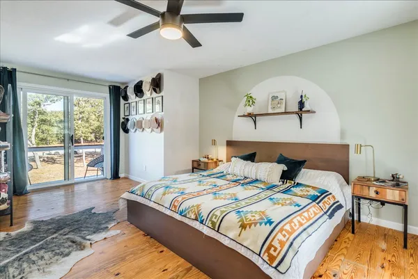 a bedroom with a large bed and a window