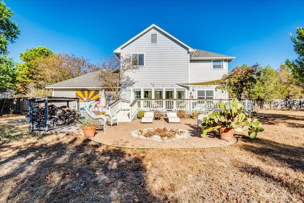 a view of a house with yard and sitting area