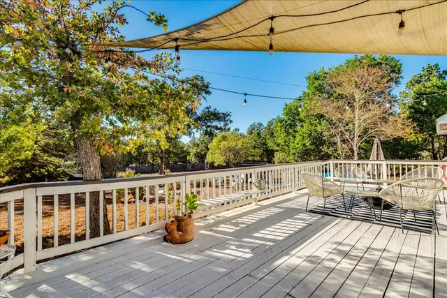 a view of balcony with wooden floor and seating space