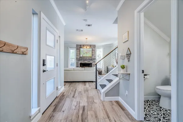 a view of a hallway with wooden floor and staircase