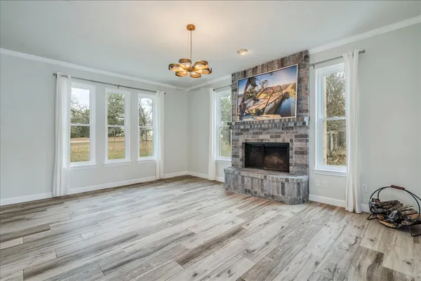a view of a livingroom with a fireplace and window