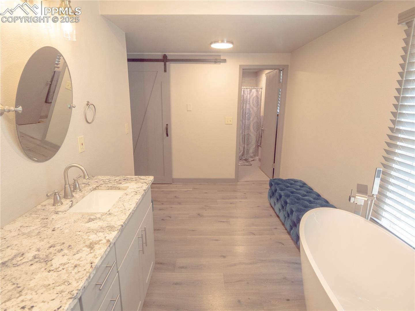4130 Walker Road Colorado Springs, CO 80908 - Photo 12 of 39 Full bathroom with wood finished floors, vanity, and a freestanding bath