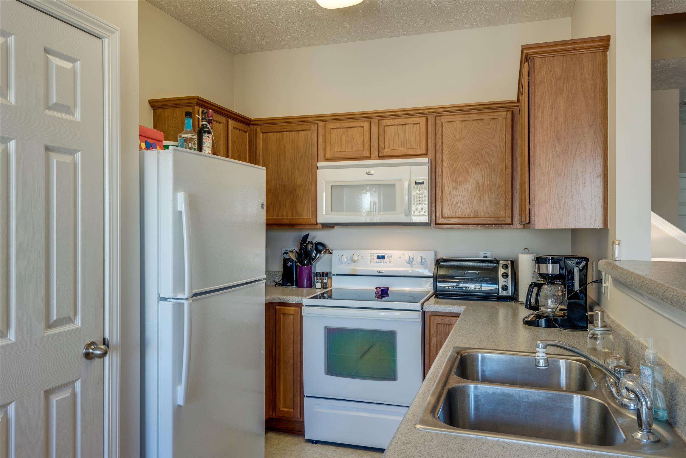 8215 Rossi Road Brentwood, TN 37027 - Photo 10 of 26 a kitchen with stainless steel appliances granite countertop a refrigerator sink and stove