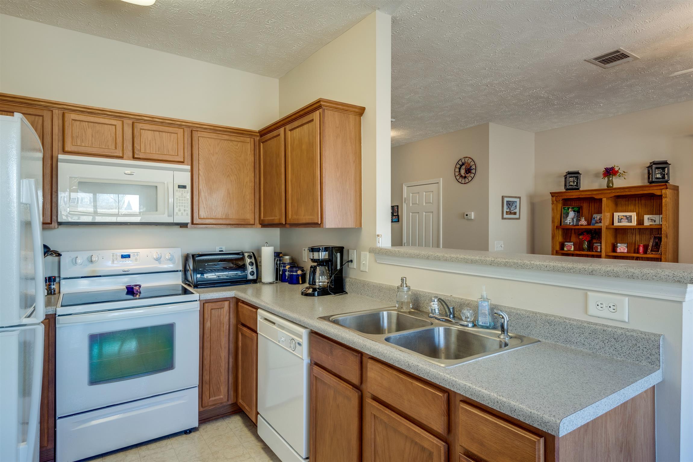 8215 Rossi Road Brentwood, TN 37027 - Photo 11 of 26 a kitchen with stainless steel appliances granite countertop a sink stove and cabinets