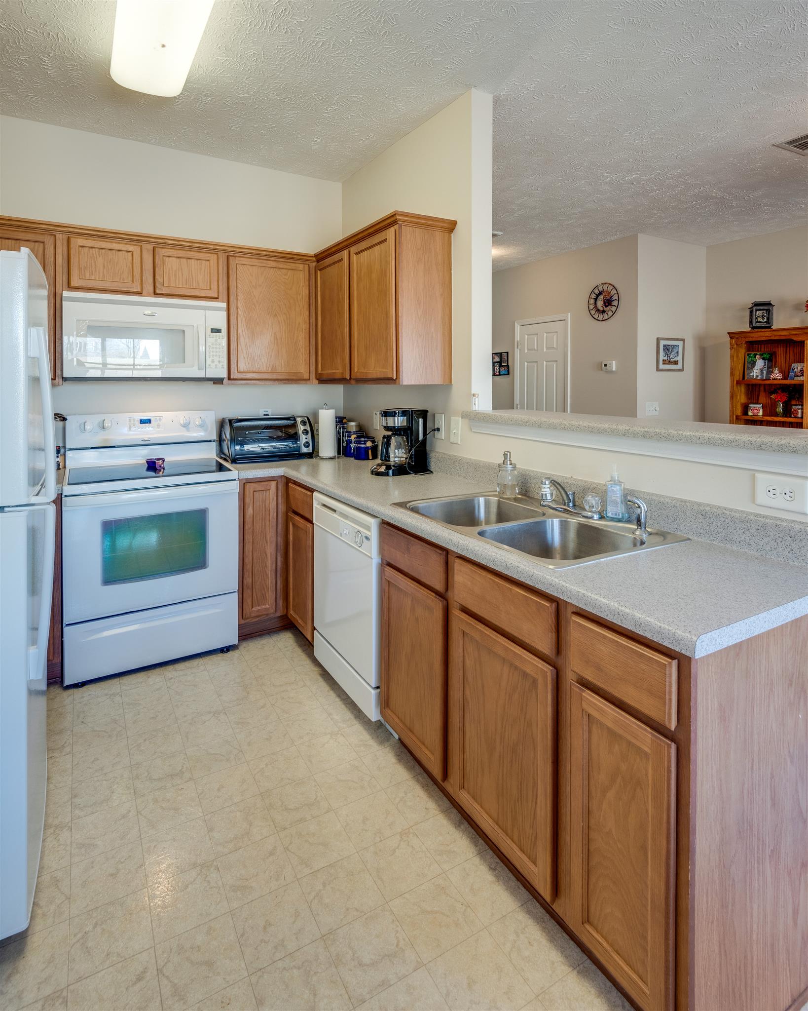 8215 Rossi Road Brentwood, TN 37027 - Photo 12 of 26 a kitchen with stainless steel appliances granite countertop a sink stove and cabinets