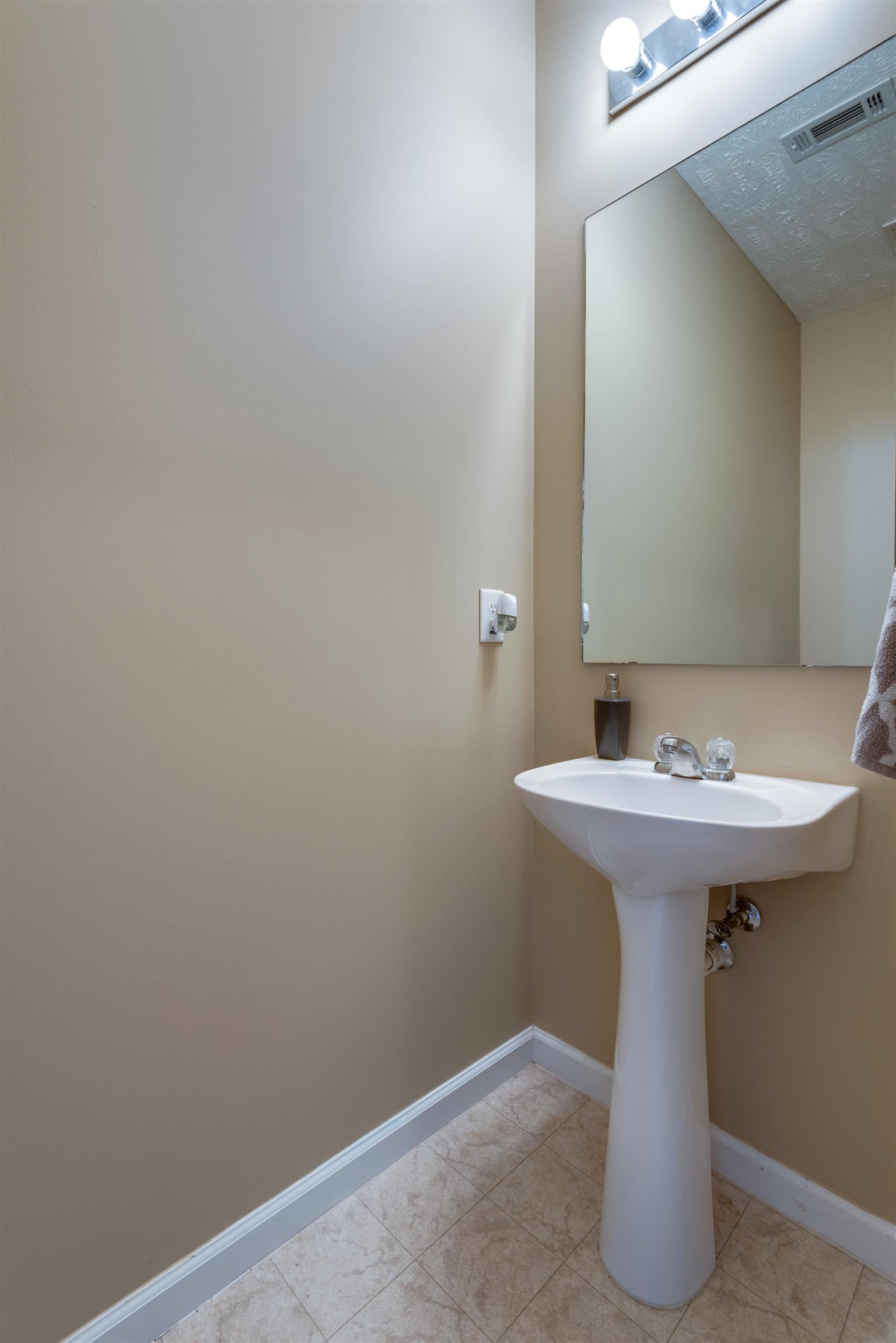8215 Rossi Road Brentwood, TN 37027 - Photo 26 of 26 a bathroom with a sink and mirror