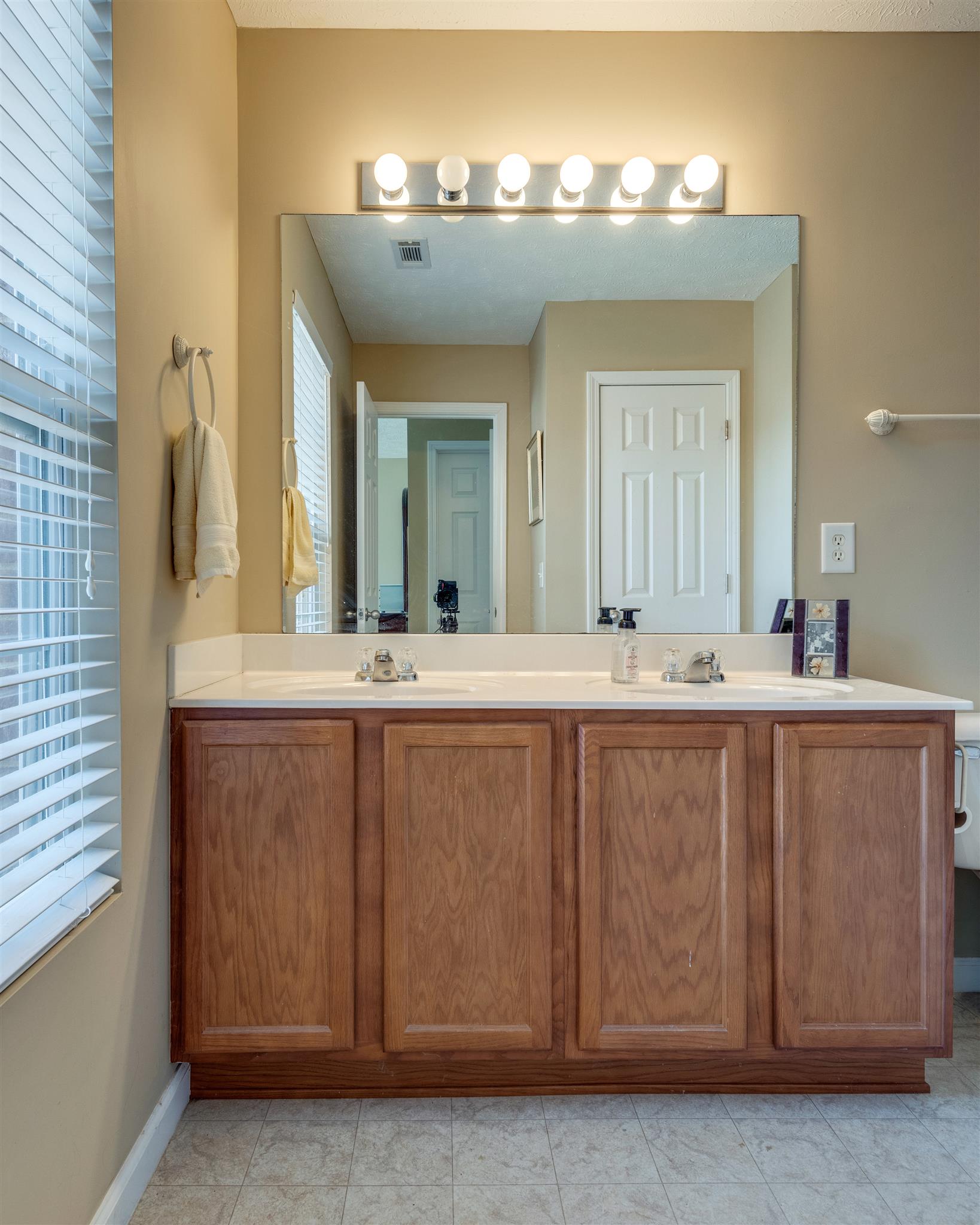 8215 Rossi Road Brentwood, TN 37027 - Photo 17 of 26 a bathroom with a sink and a mirror