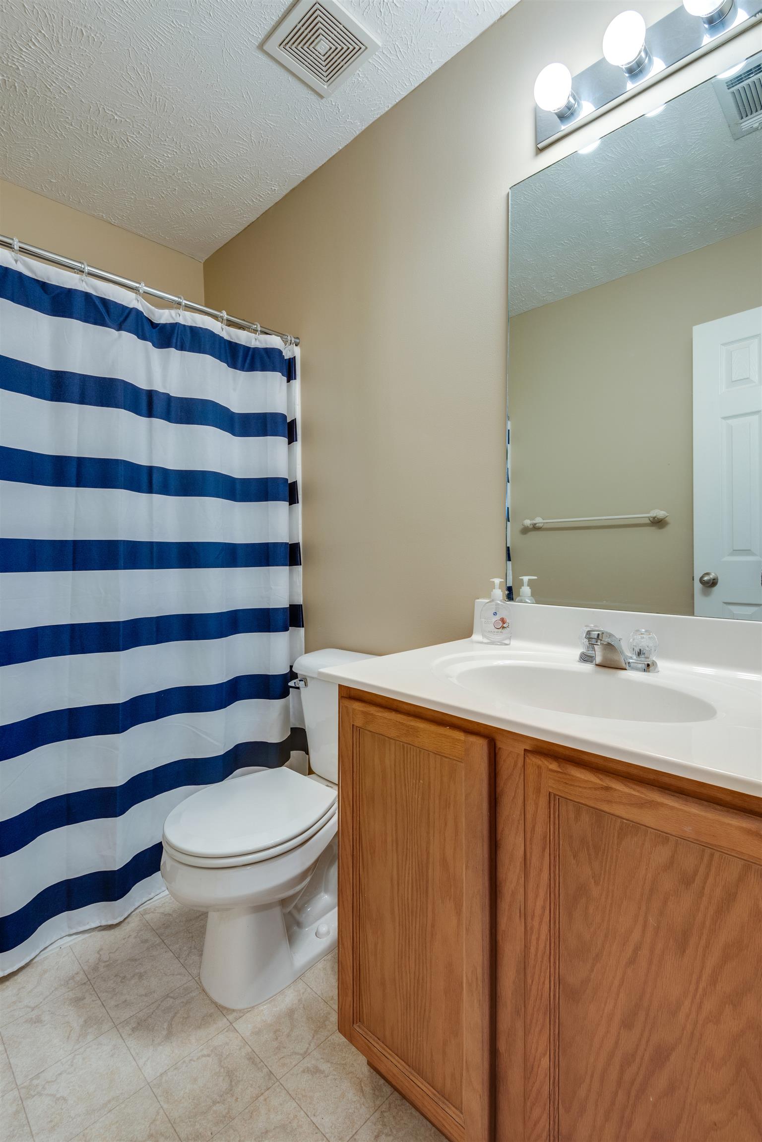 8215 Rossi Road Brentwood, TN 37027 - Photo 20 of 26 a bathroom with a sink toilet and shower