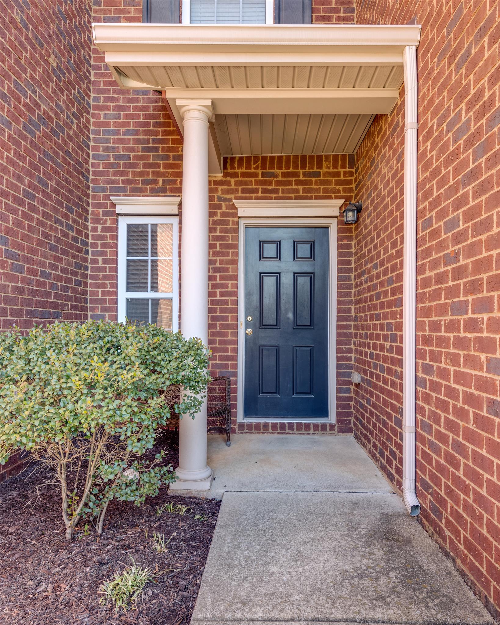 8215 Rossi Road Brentwood, TN 37027 - Photo 4 of 26 a front view of a house with a garden