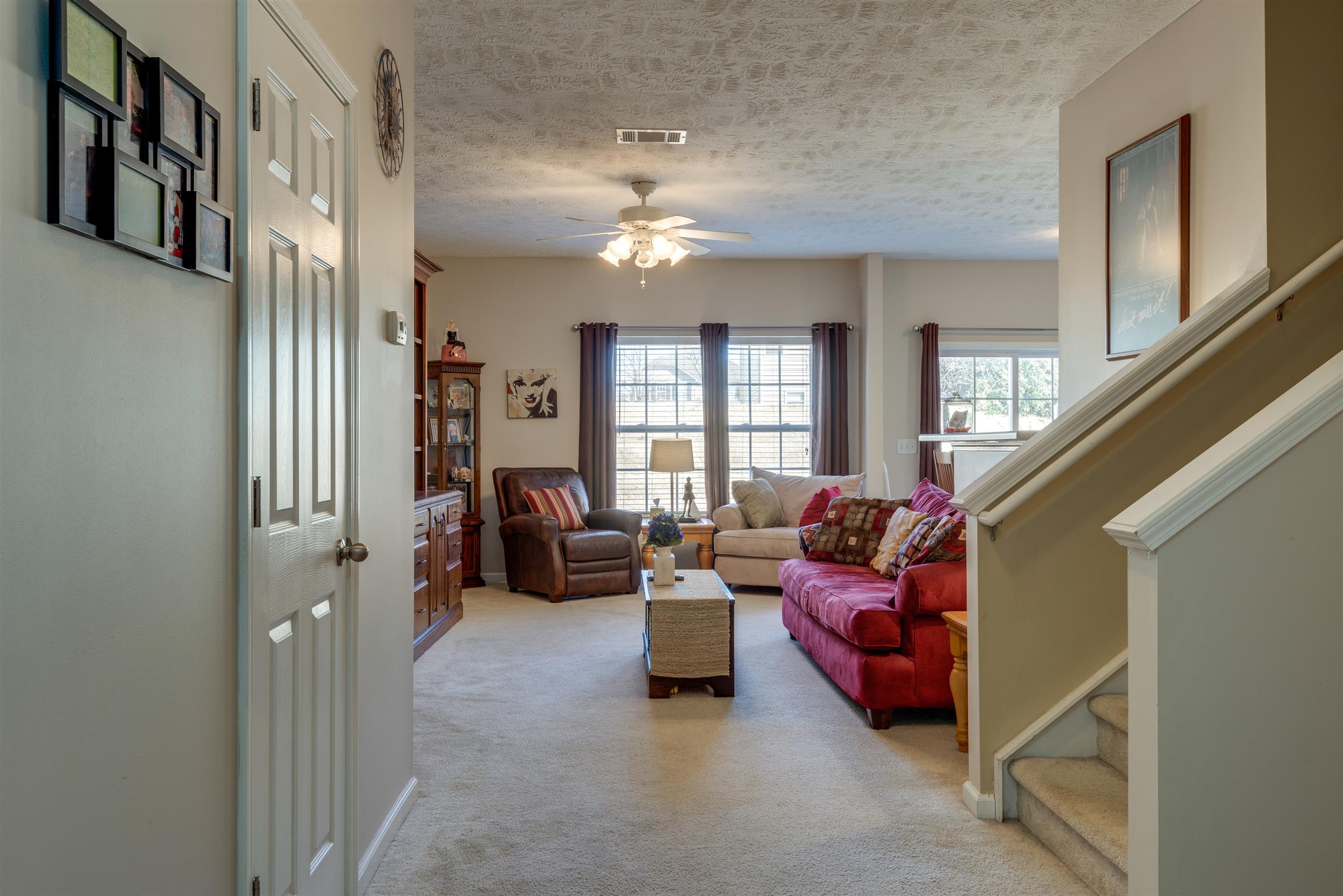 8215 Rossi Road Brentwood, TN 37027 - Photo 5 of 26 a living room with furniture and a chandelier