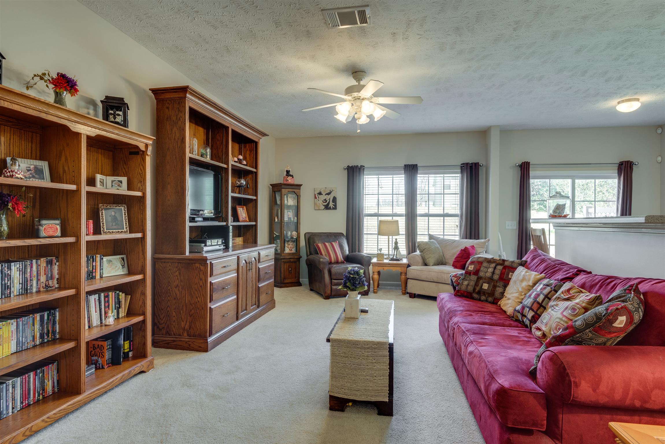8215 Rossi Road Brentwood, TN 37027 - Photo 25 of 26 a living room with furniture and a book shelf