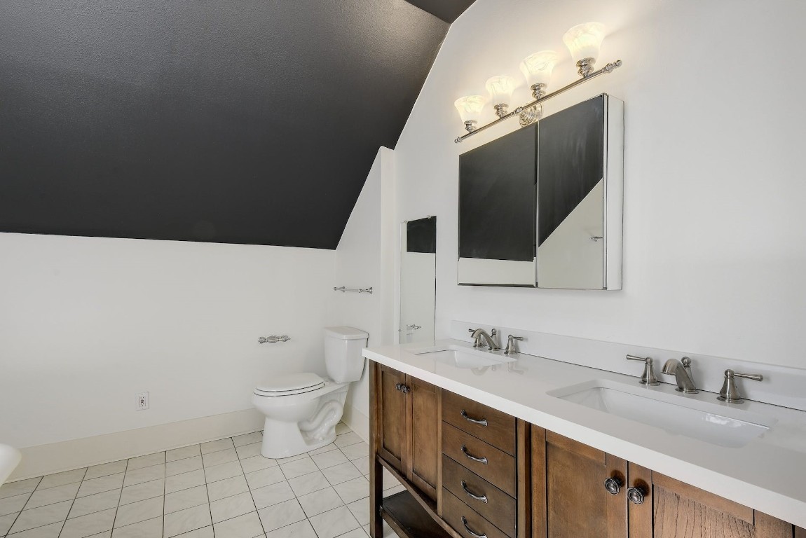 205 South Rio Grande Street Lockhart, TX 78644 - Photo 23 of 30 a bathroom with a granite countertop sink mirror and toilet