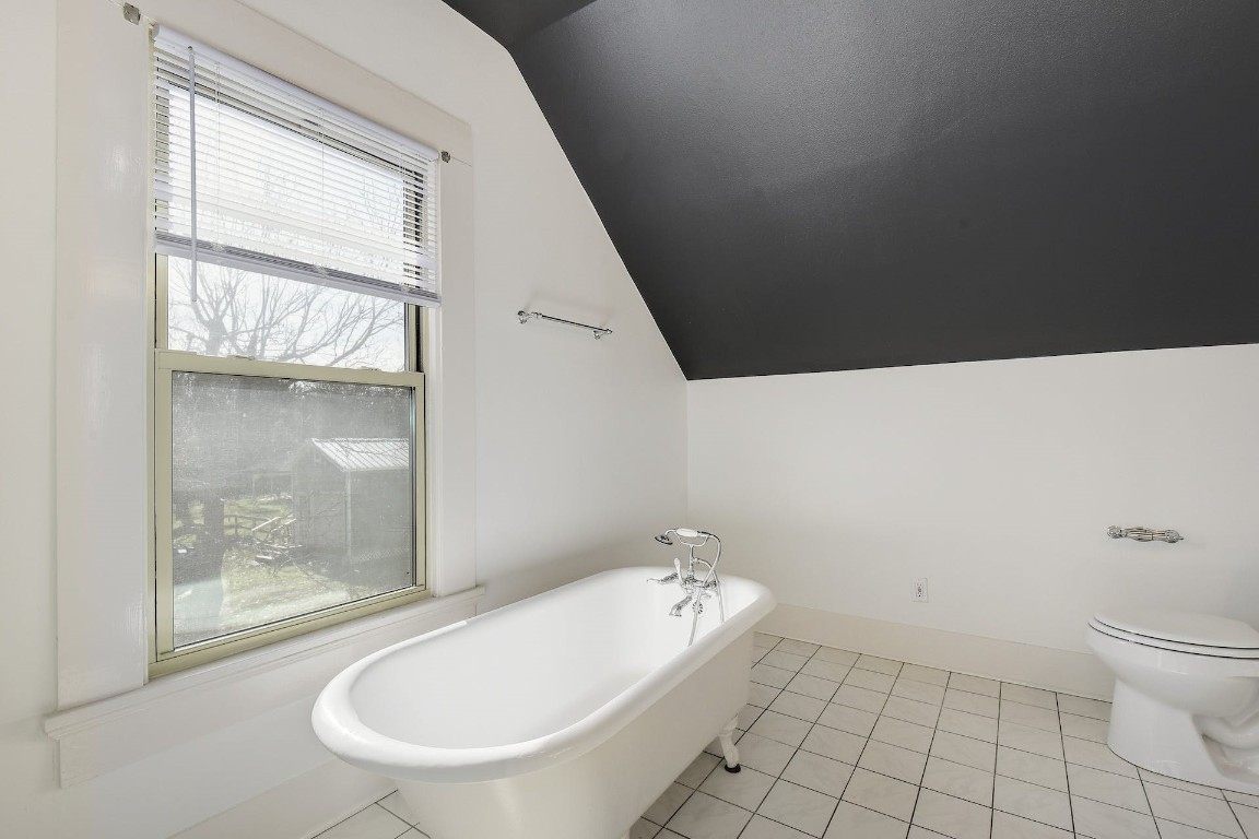 205 South Rio Grande Street Lockhart, TX 78644 - Photo 24 of 30 a bathroom with a bathtub and toilet