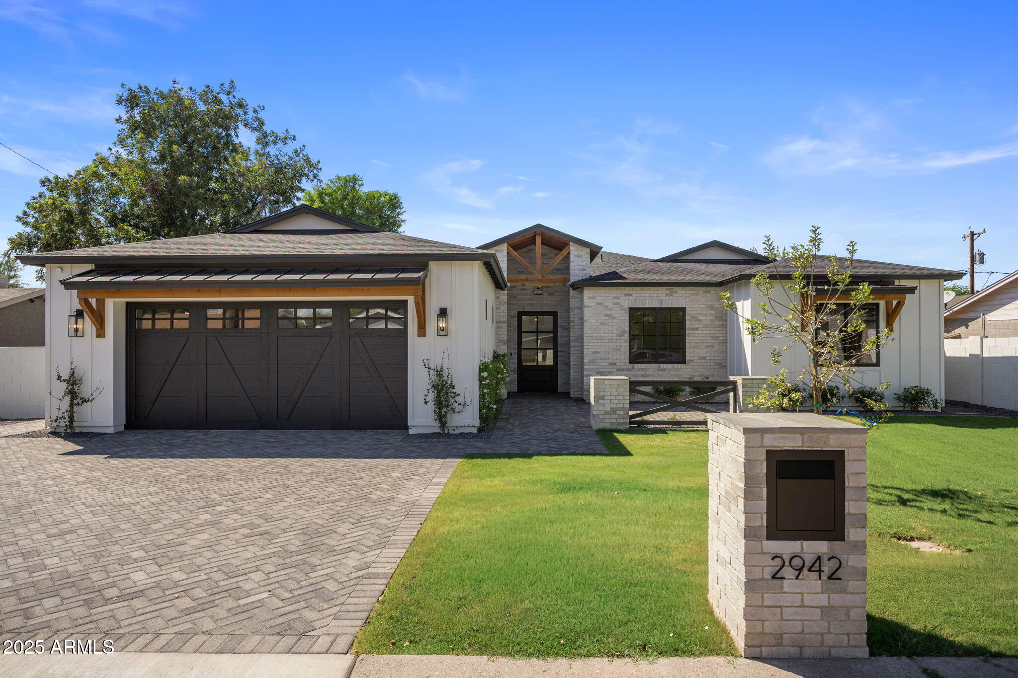 2942 North 47th Place Phoenix, AZ 85018 - Photo 1 of 40 a front view of a house with a garden and yard