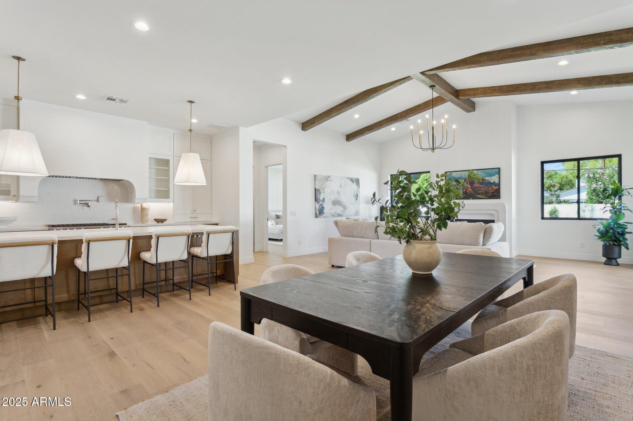 2942 North 47th Place Phoenix, AZ 85018 - Photo 12 of 40 a view of a dining room with furniture and a potted plant