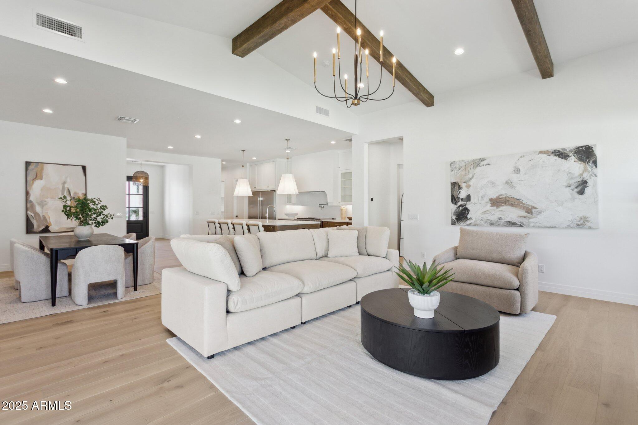 2942 North 47th Place Phoenix, AZ 85018 - Photo 13 of 40 a living room with furniture and a chandelier
