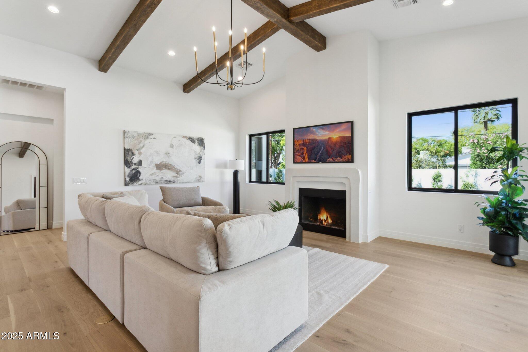 2942 North 47th Place Phoenix, AZ 85018 - Photo 14 of 40 a living room with furniture a fireplace and a flat screen tv