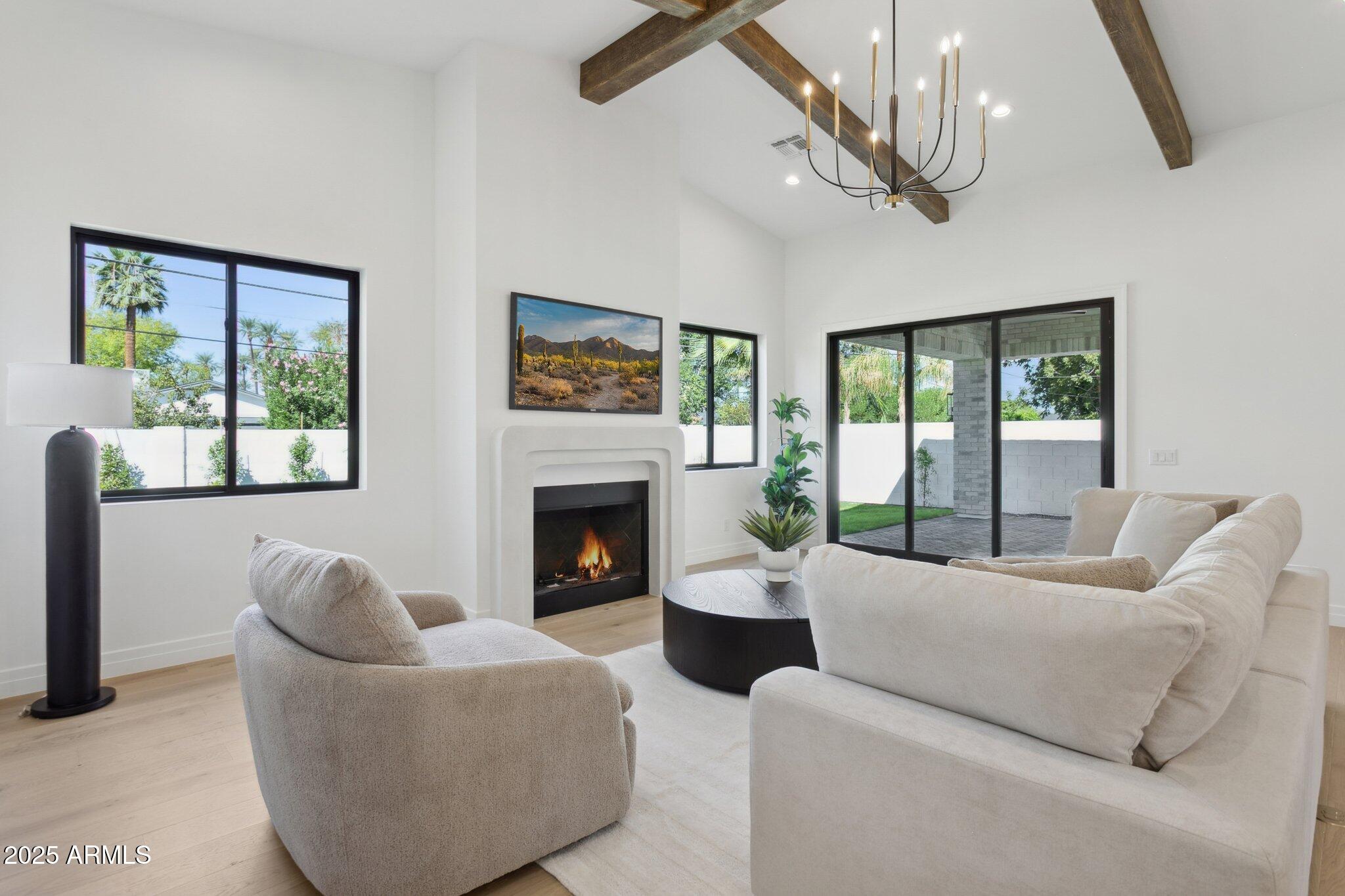 2942 North 47th Place Phoenix, AZ 85018 - Photo 15 of 40 a living room with furniture a large window and a fireplace