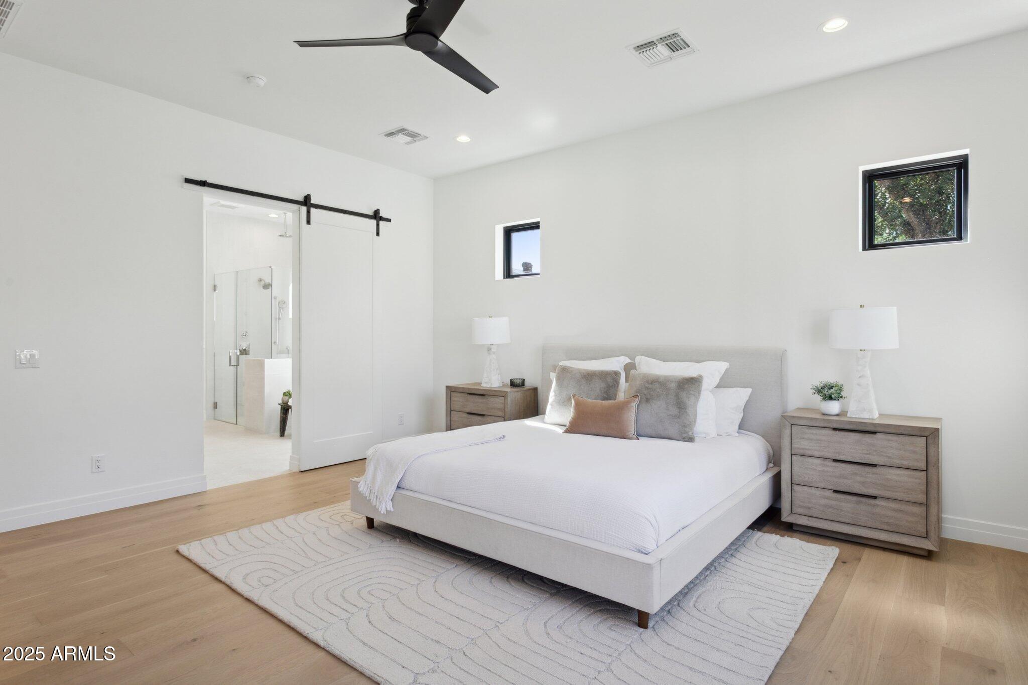 2942 North 47th Place Phoenix, AZ 85018 - Photo 16 of 40 a bedroom with a bed and a ceiling fan