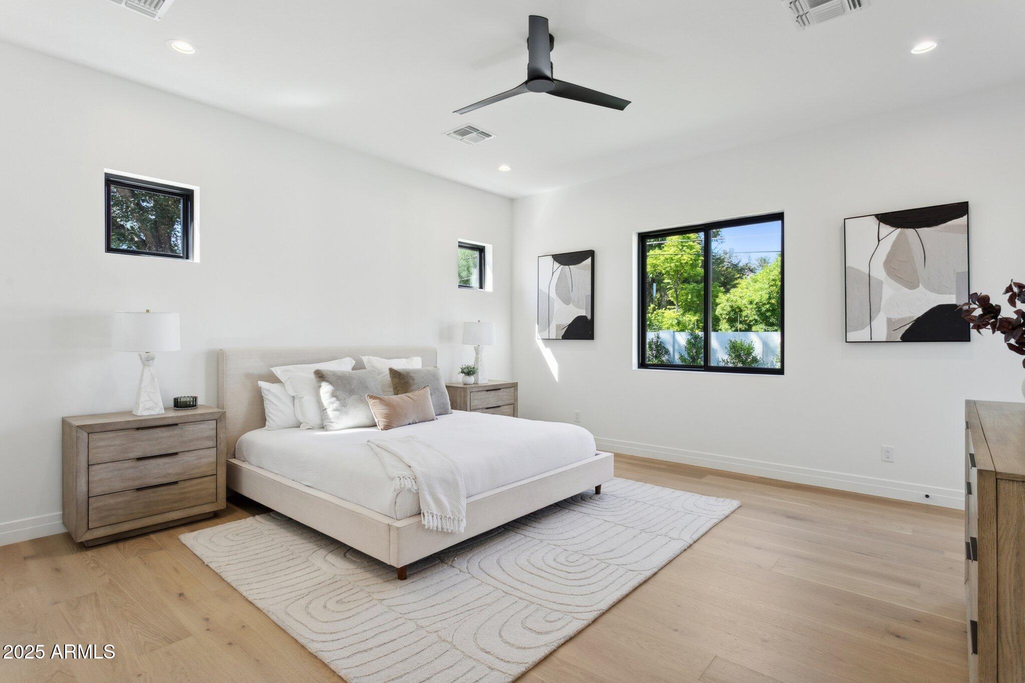 2942 North 47th Place Phoenix, AZ 85018 - Photo 17 of 40 a bedroom with a large bed and a window
